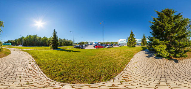View of the terminal building through the branches of perennial coniferous trees