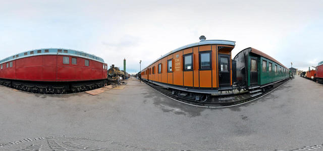 A platform under the open sky with railway equipment.