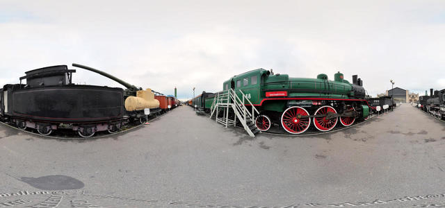 A platform under the open sky with railway equipment.